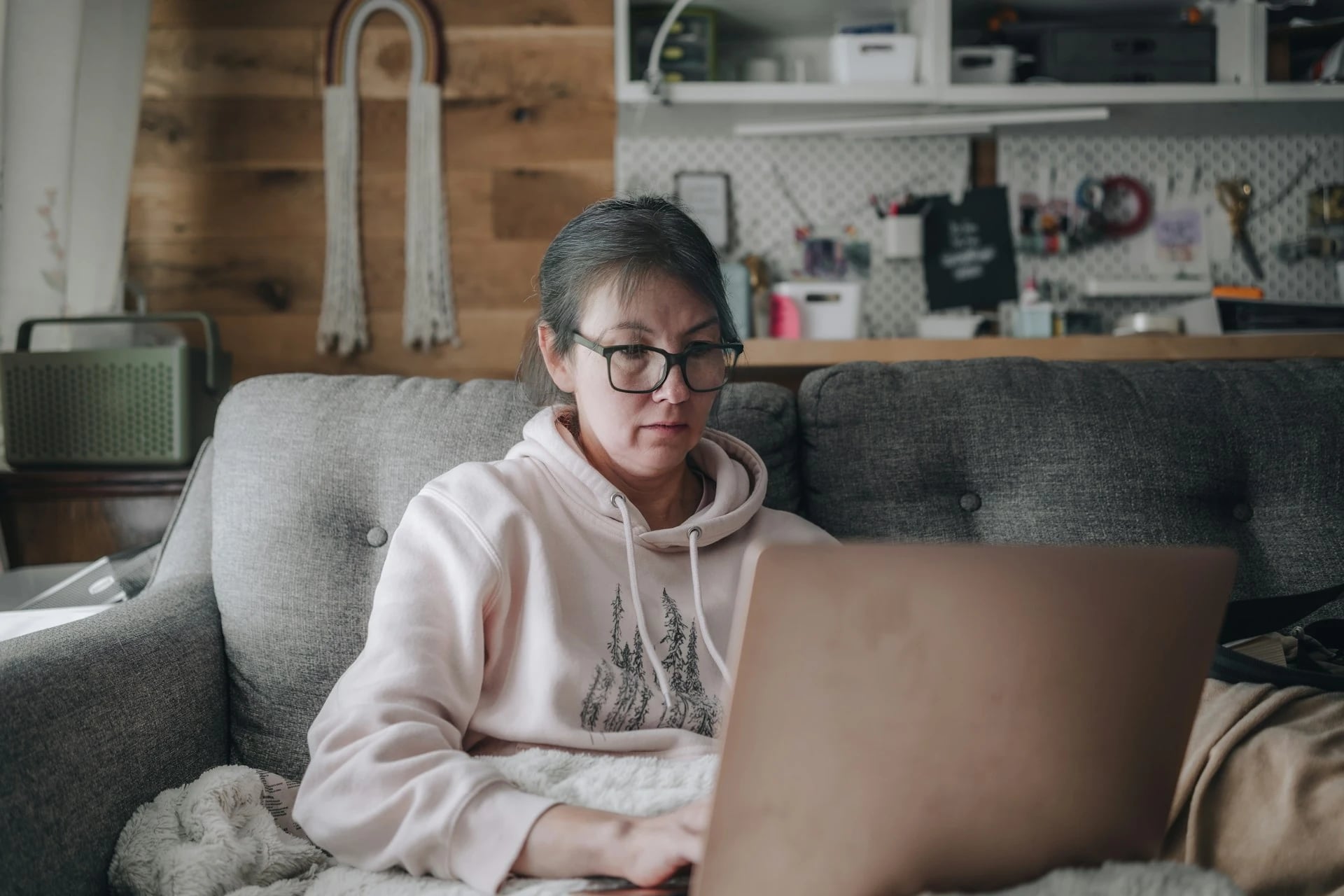 Woman researching weight loss injection costs on her laptop at home