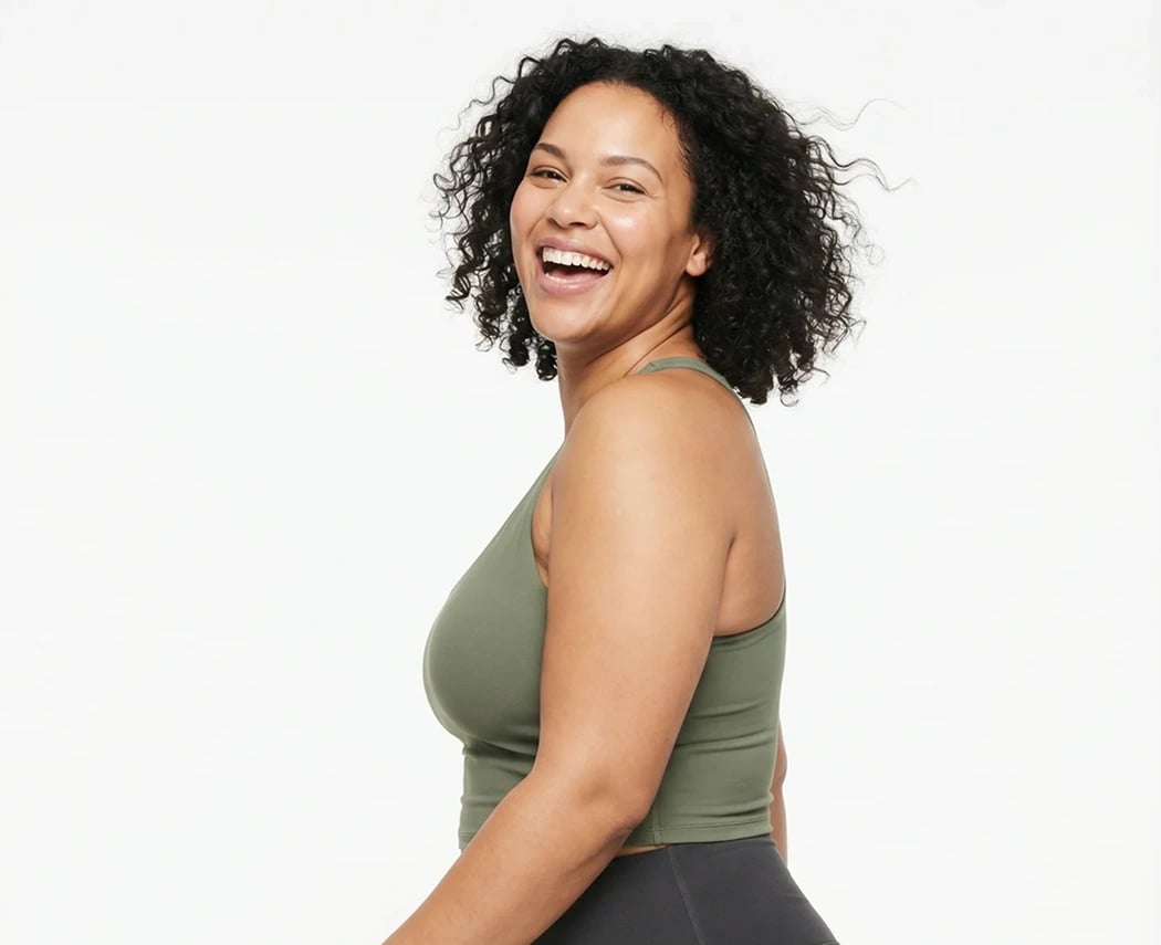 Woman smiling confidently, representing wellness and health